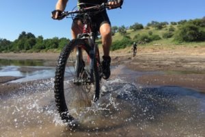 northern tuli botswana cycling safari ridign through water